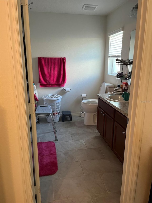 bathroom with vanity and toilet