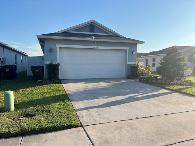 single story home featuring a front yard and a garage