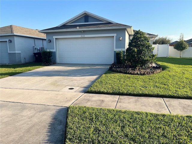 single story home with a garage and a front lawn