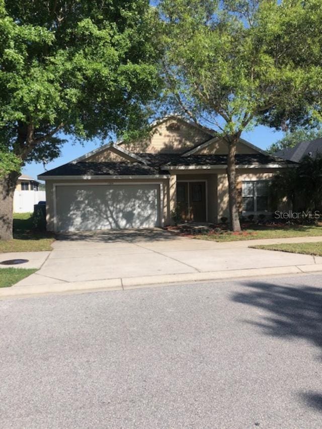 view of front of home with a garage and concrete driveway