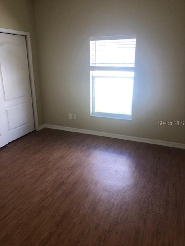 unfurnished bedroom featuring dark hardwood / wood-style floors