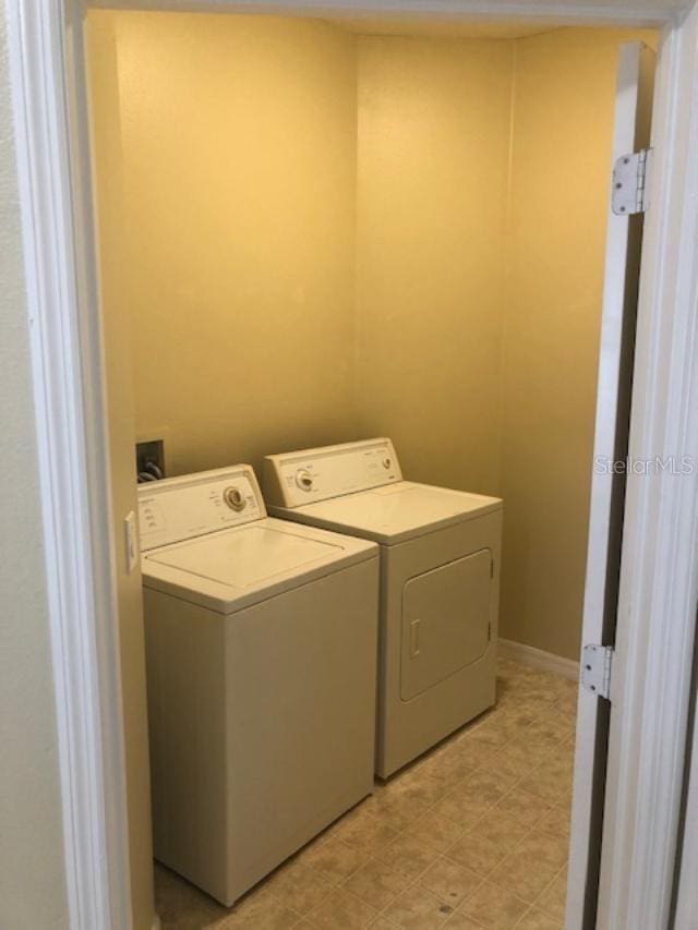 laundry room with washing machine and clothes dryer