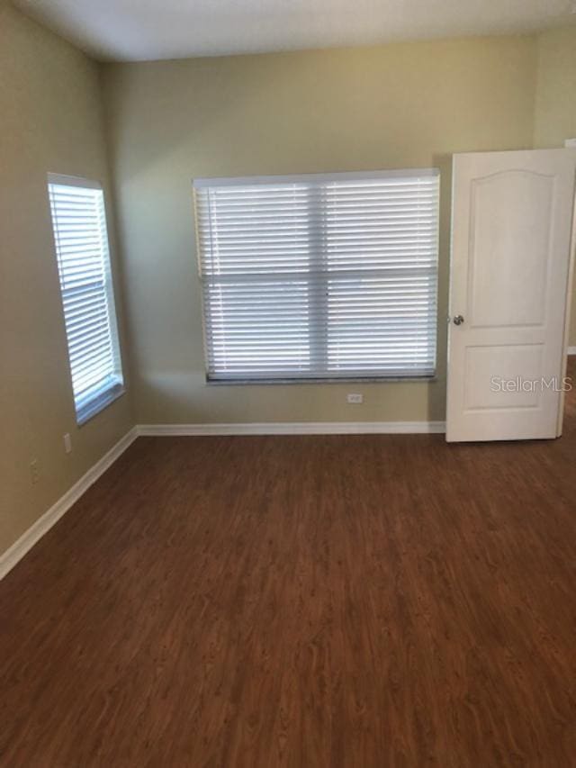 spare room featuring dark hardwood / wood-style flooring