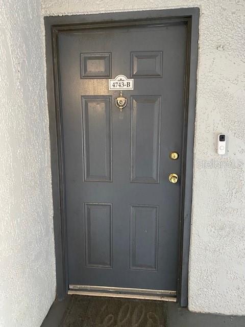 property entrance with stucco siding