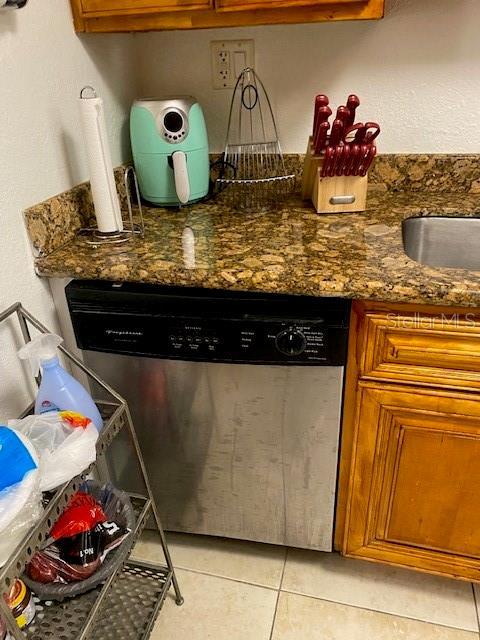 interior details with brown cabinets and stainless steel dishwasher