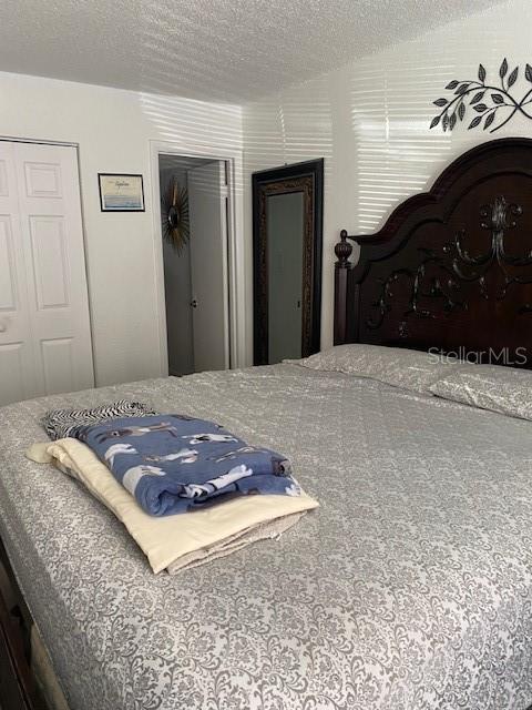 bedroom featuring carpet floors and a textured ceiling