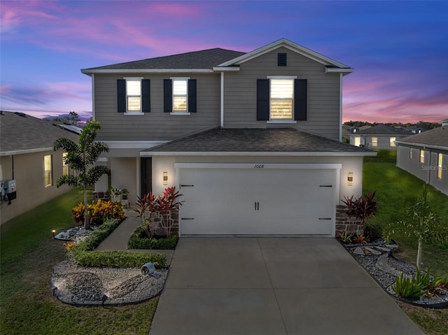 front facade featuring a yard and a garage