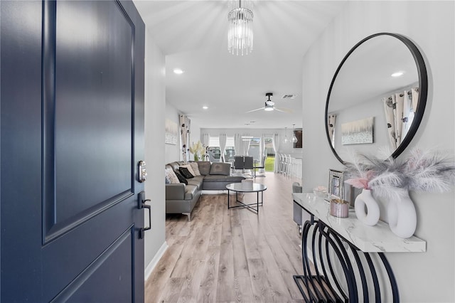 living room with light wood-type flooring and ceiling fan