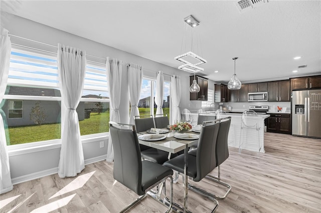 dining space featuring light hardwood / wood-style floors