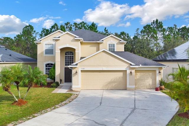 view of front property with a front lawn and a garage