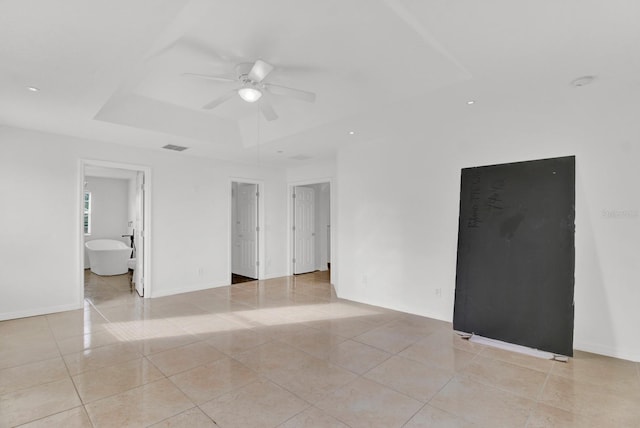 tiled spare room with ceiling fan