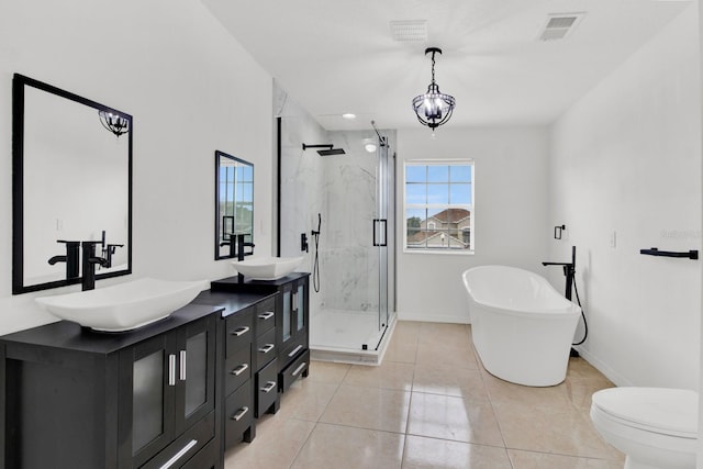 full bathroom featuring toilet, vanity, tile patterned floors, and separate shower and tub