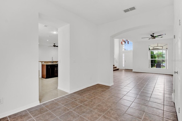 tiled empty room with ceiling fan