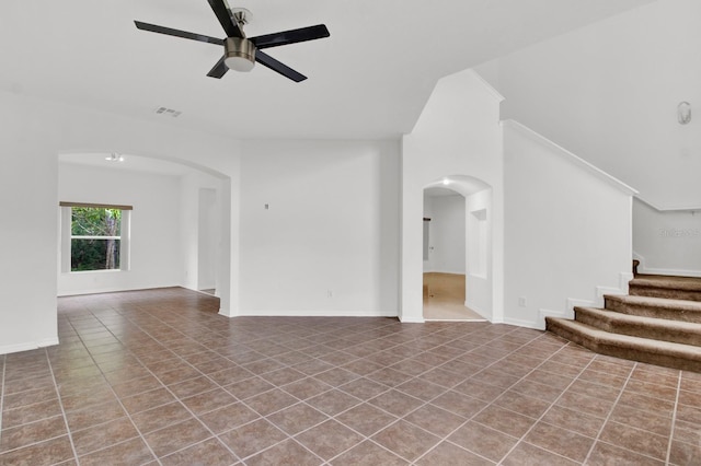 unfurnished living room with ceiling fan and tile patterned floors