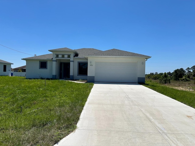 view of front of home featuring a front lawn and a garage