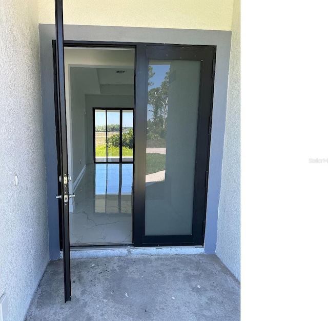 doorway to property with stucco siding