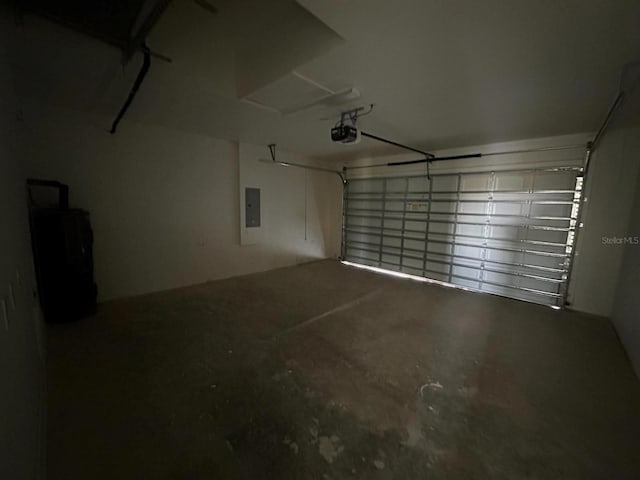 garage with a garage door opener and electric panel