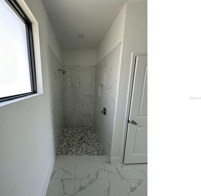 full bathroom with marble finish floor, baseboards, and a marble finish shower