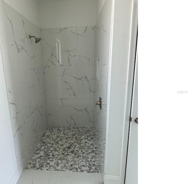 bathroom with tiled shower