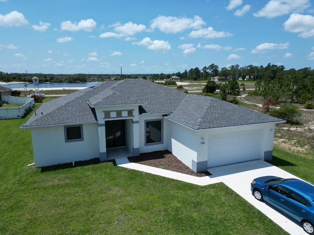 view of front of house featuring a garage, a front yard, a shingled roof, and stucco siding