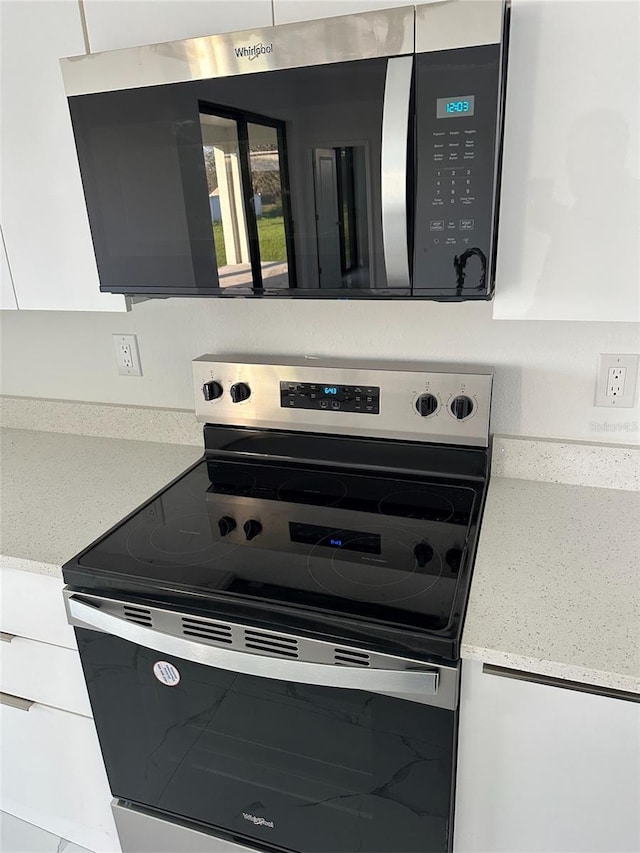 interior details with stainless steel appliances and light stone counters