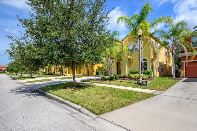 view of front of property featuring a front lawn and a garage