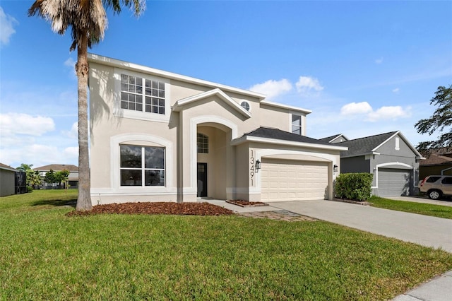 view of front of house with a front yard and a garage