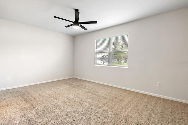 spare room featuring ceiling fan and carpet