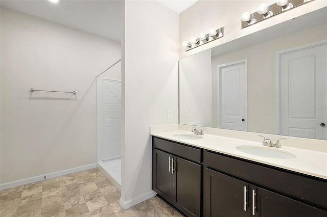 bathroom featuring walk in shower and vanity