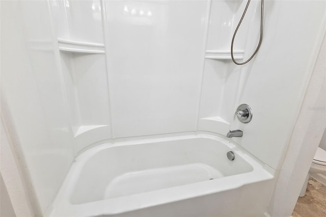 bathroom featuring shower / tub combo with curtain and toilet