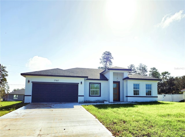 view of front of home featuring a front yard and a garage