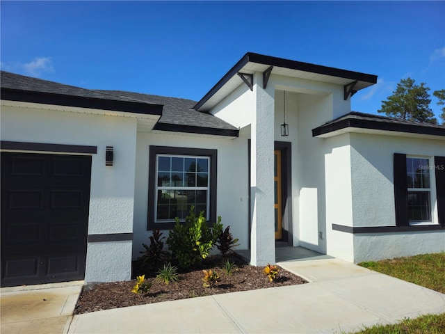 view of exterior entry with a garage