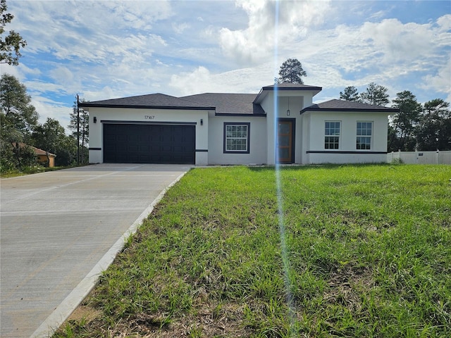 ranch-style home featuring a front yard and a garage