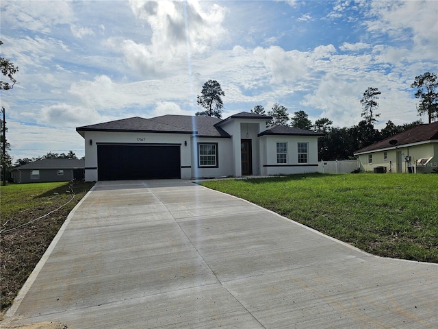 view of front of home with a front lawn and a garage