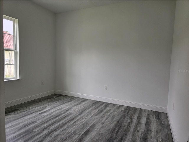 spare room with dark hardwood / wood-style flooring