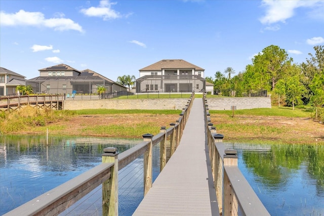 dock area with a water view and a yard