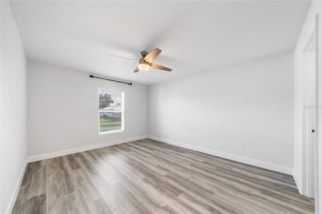 unfurnished room featuring light wood-type flooring and ceiling fan