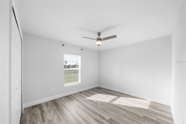 spare room featuring ceiling fan and light hardwood / wood-style flooring