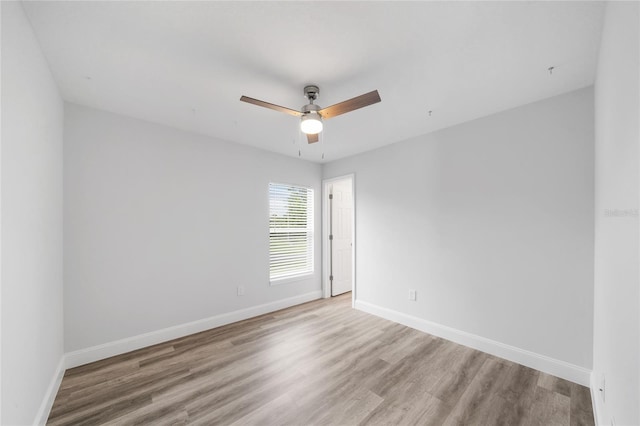 spare room with ceiling fan and hardwood / wood-style floors