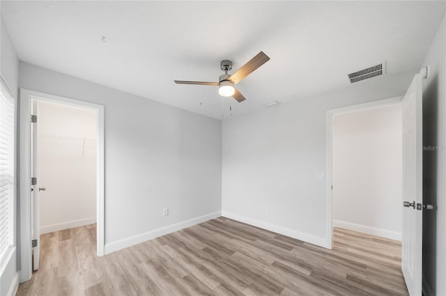 empty room with light hardwood / wood-style floors and ceiling fan