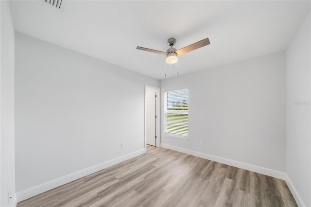 empty room with light hardwood / wood-style flooring and ceiling fan