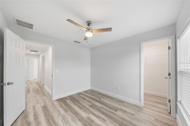 spare room featuring light hardwood / wood-style flooring and ceiling fan