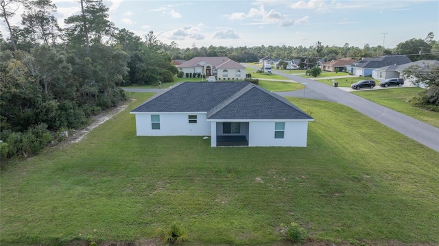 rear view of house with a lawn