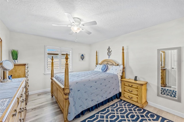 bedroom with a textured ceiling, light wood-type flooring, and ceiling fan