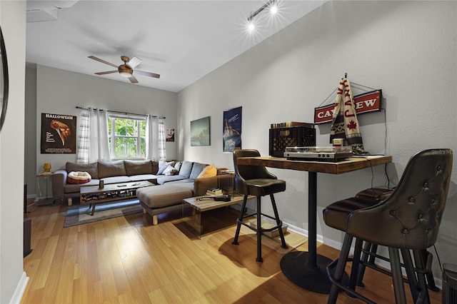 living room featuring hardwood / wood-style floors and ceiling fan