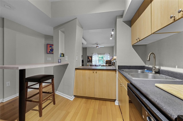 kitchen with ceiling fan, sink, light brown cabinets, light hardwood / wood-style flooring, and kitchen peninsula