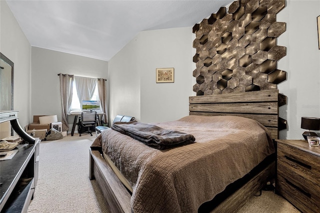 bedroom with carpet floors and lofted ceiling