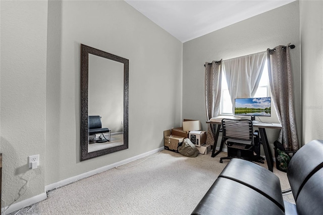 sitting room featuring carpet flooring and vaulted ceiling