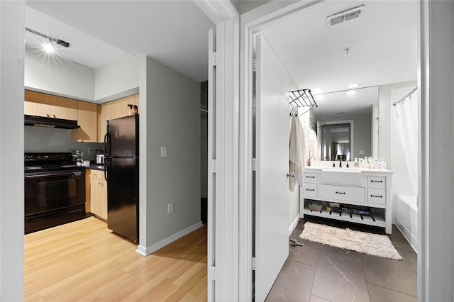 bathroom featuring hardwood / wood-style flooring and vanity