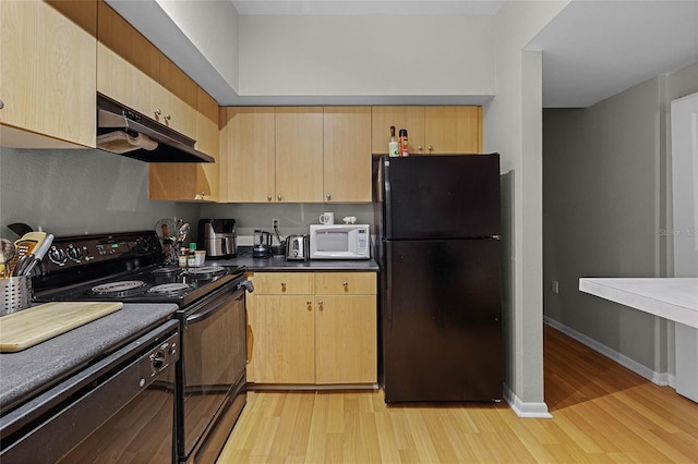 kitchen featuring light brown cabinets, light hardwood / wood-style floors, and black appliances